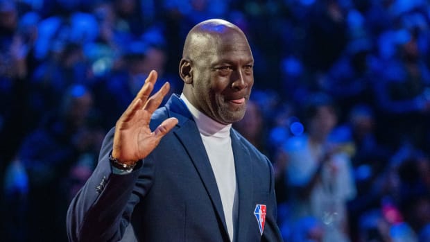Michael Jordan waves to fans during a ceremony.